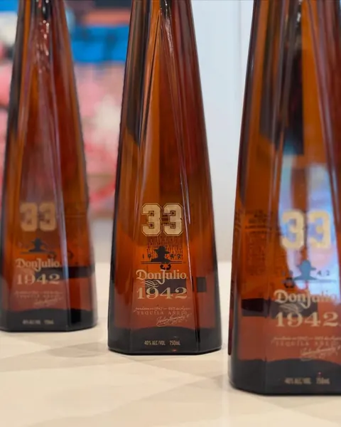 Don Julio 1942 bottles engraved with the number 33 and filled with gold.