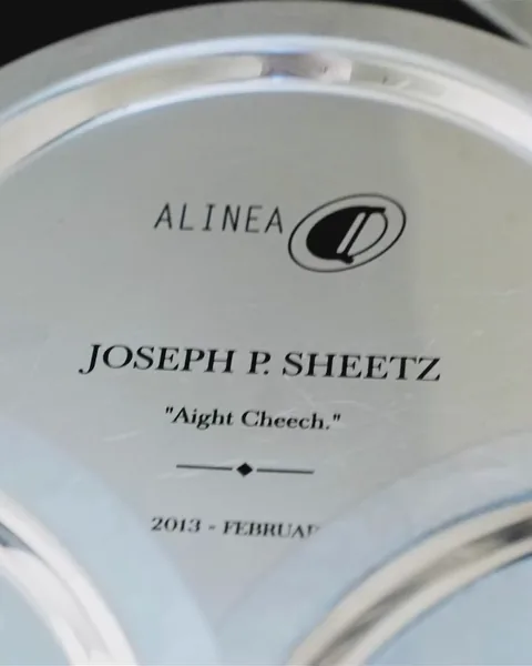 A name plate engraved for a member of Alinea’s team, with his name and a line in his honour.