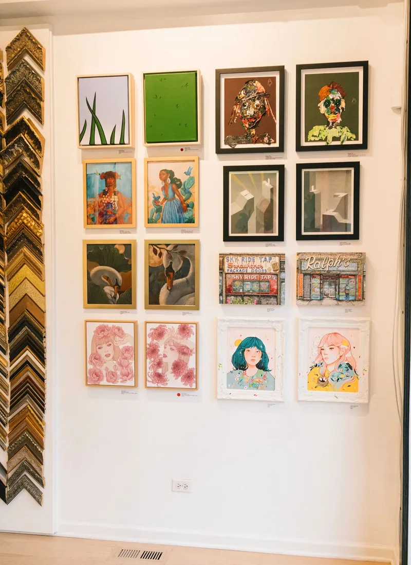 A show of framed works on a white wall at Frame Chicago, beside a column of frame corners.